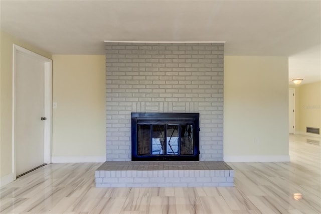 interior details featuring hardwood / wood-style flooring and a brick fireplace