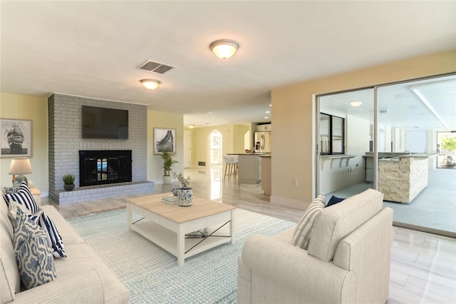 living room with a brick fireplace