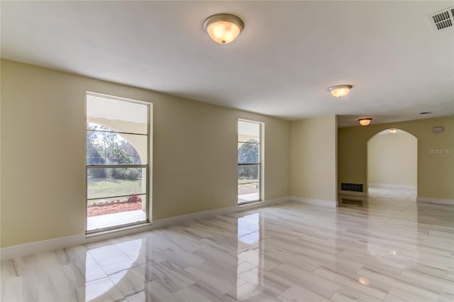 unfurnished room featuring a healthy amount of sunlight