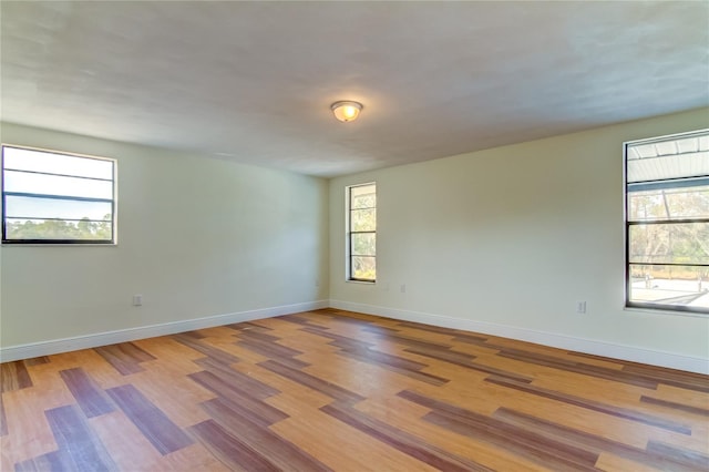 empty room with light hardwood / wood-style flooring