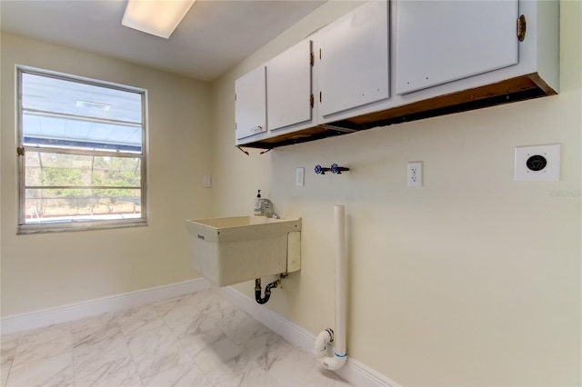 clothes washing area with hookup for an electric dryer, cabinets, and washer hookup