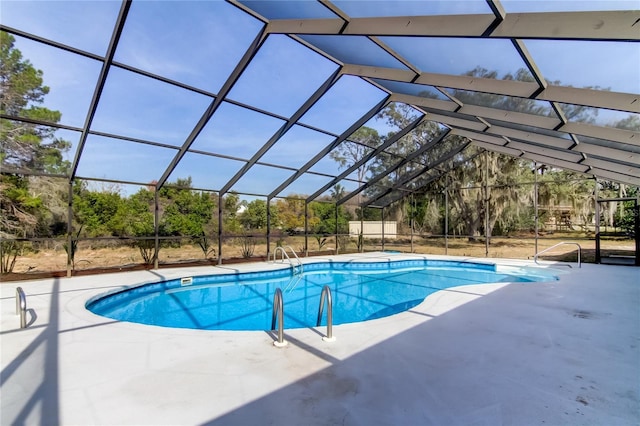 view of pool with a patio area and a lanai