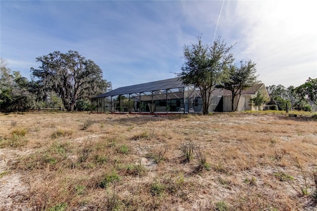 view of yard featuring glass enclosure