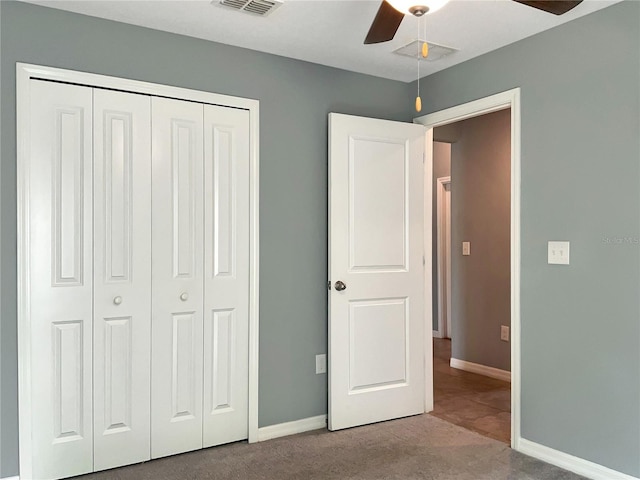 unfurnished bedroom featuring light carpet, ceiling fan, and a closet