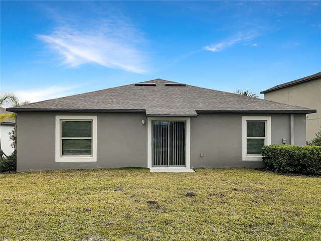 rear view of property with a yard