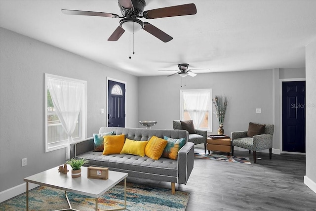 living room with wood-type flooring and ceiling fan