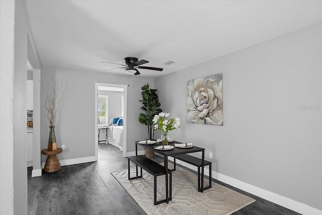 dining room featuring ceiling fan and dark hardwood / wood-style flooring