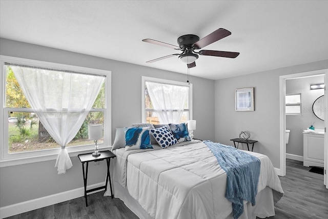 bedroom with dark hardwood / wood-style flooring and multiple windows