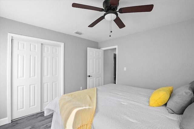 bedroom featuring a closet, ceiling fan, and dark hardwood / wood-style flooring