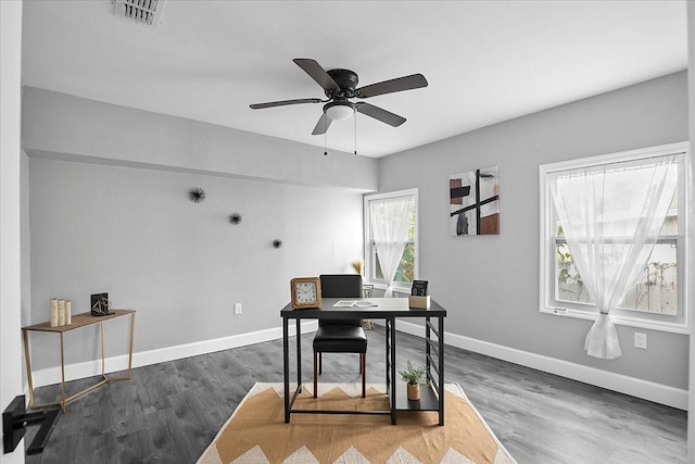 home office with ceiling fan and dark wood-type flooring