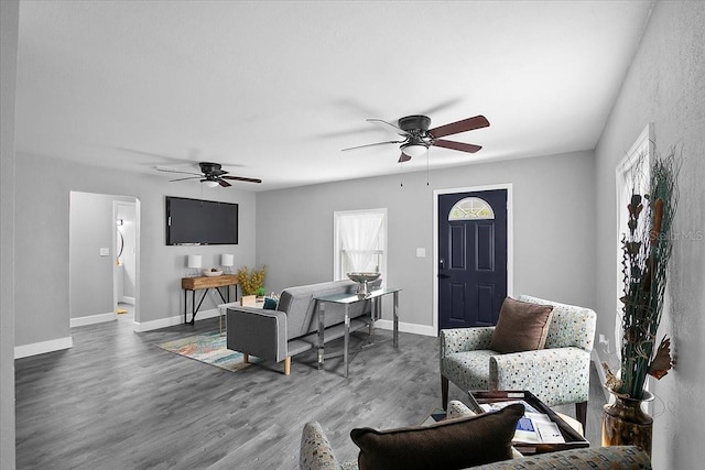 living room with dark hardwood / wood-style floors and ceiling fan