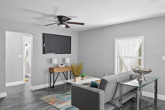 living room with ceiling fan and dark wood-type flooring