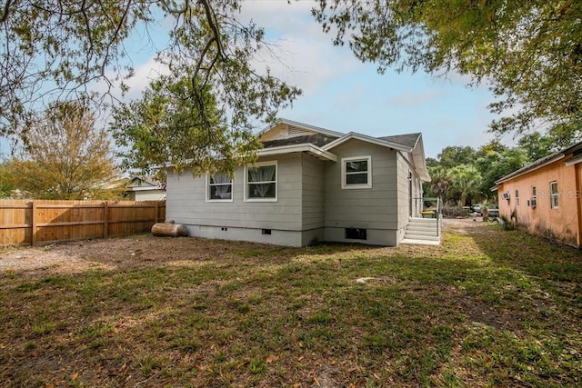 back of property featuring a yard