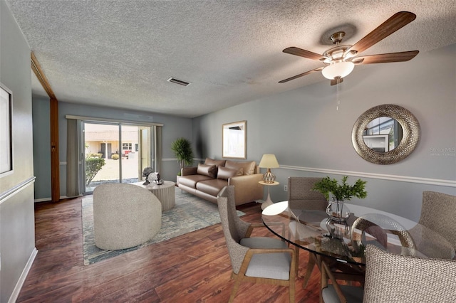 living room featuring ceiling fan and dark hardwood / wood-style flooring