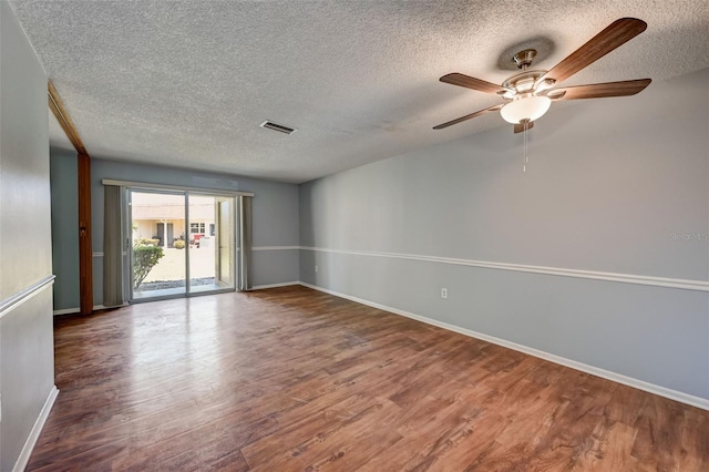 spare room with ceiling fan, a textured ceiling, and hardwood / wood-style flooring