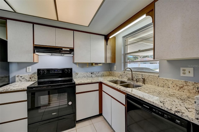 kitchen featuring black appliances, white cabinetry, sink, and light tile patterned floors