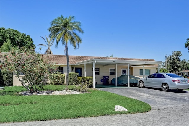 single story home with a front yard and a carport