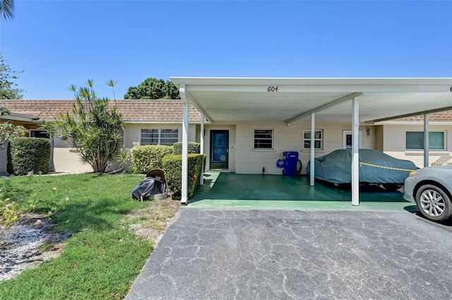 view of front facade with a front yard and a carport