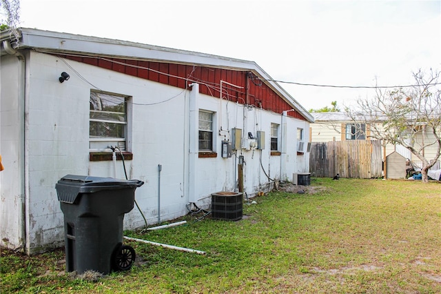 exterior space featuring central AC unit and a yard