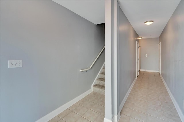 stairway with tile patterned floors