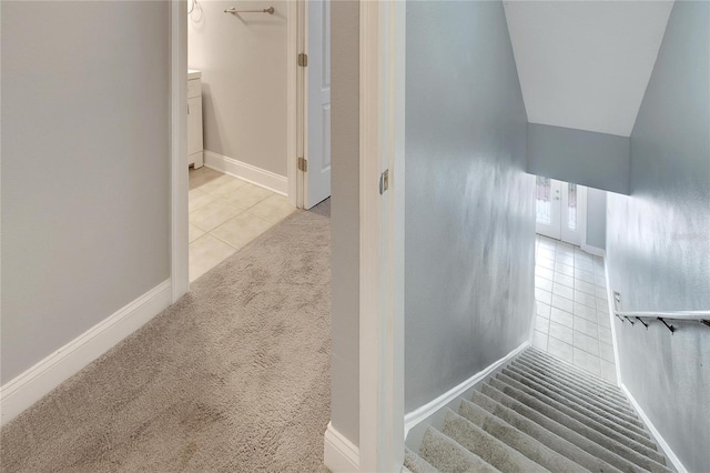 staircase with carpet flooring and vaulted ceiling