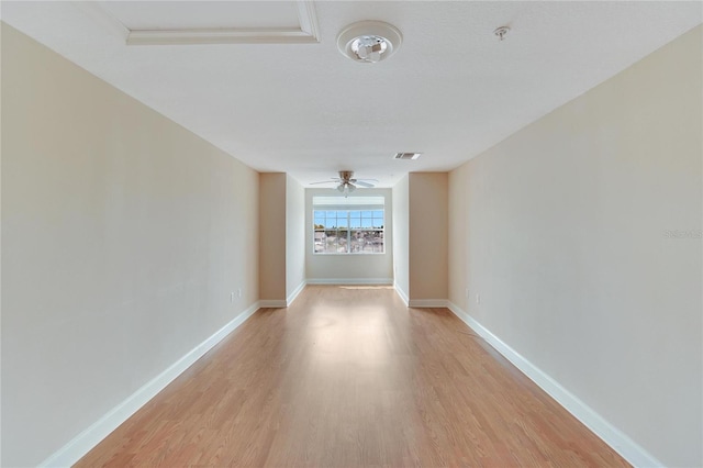 empty room with ceiling fan and light wood-type flooring