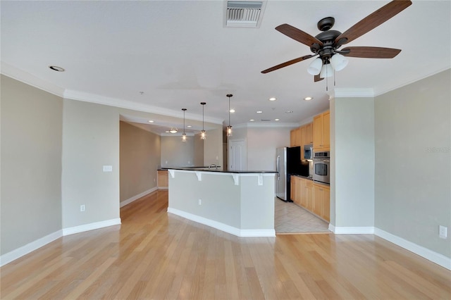 kitchen with pendant lighting, a kitchen island with sink, ornamental molding, light wood-type flooring, and stainless steel appliances