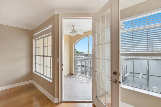 doorway to outside featuring crown molding, french doors, ceiling fan, and light wood-type flooring