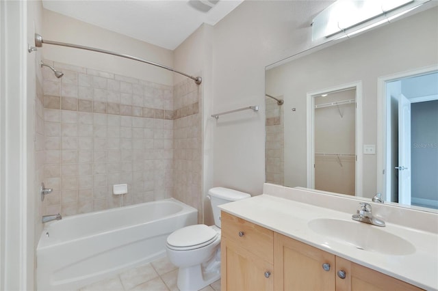 full bathroom with tile patterned flooring, vanity, toilet, and tiled shower / bath