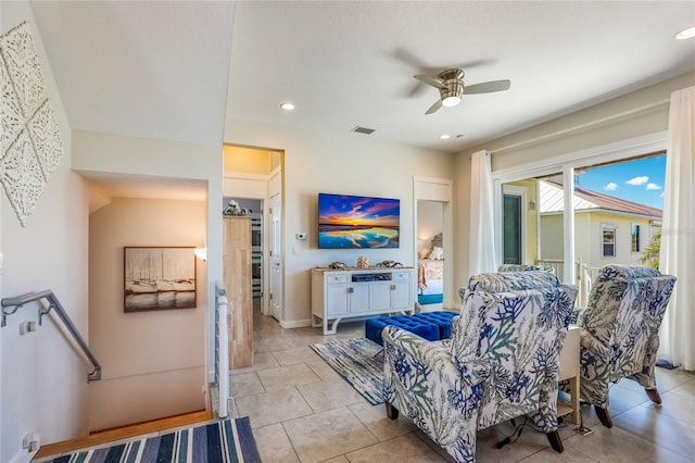 living room featuring ceiling fan and light tile patterned floors