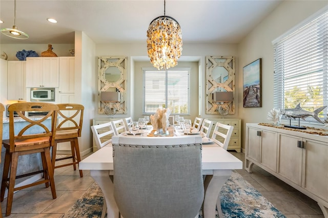 dining space featuring a notable chandelier and light tile patterned floors