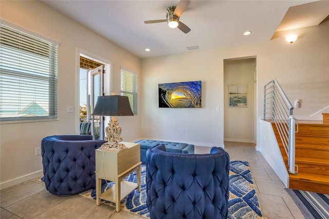 sitting room featuring light tile patterned floors, plenty of natural light, and ceiling fan