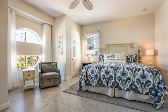 tiled bedroom with ceiling fan and a closet