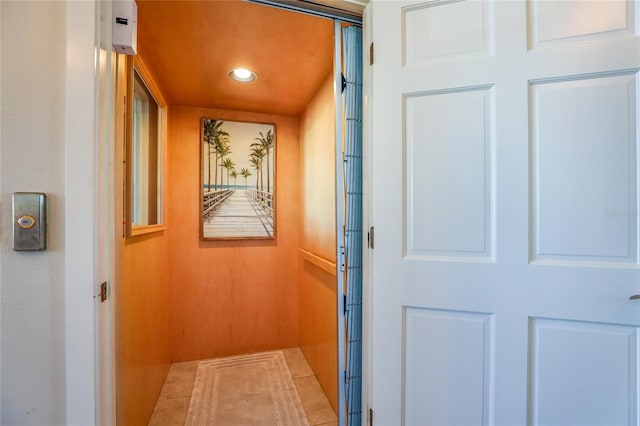 doorway featuring tile patterned floors and elevator