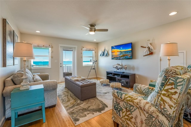 living room featuring hardwood / wood-style floors, plenty of natural light, and ceiling fan