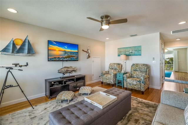 living room featuring ceiling fan and wood-type flooring