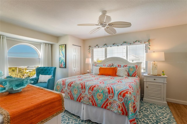 bedroom featuring hardwood / wood-style flooring, ceiling fan, and a closet