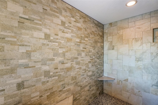 bathroom with a tile shower