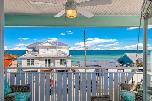 exterior space featuring a water view, ceiling fan, and a balcony