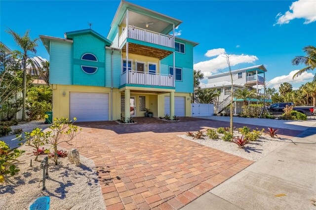 view of front of property featuring a balcony and a garage