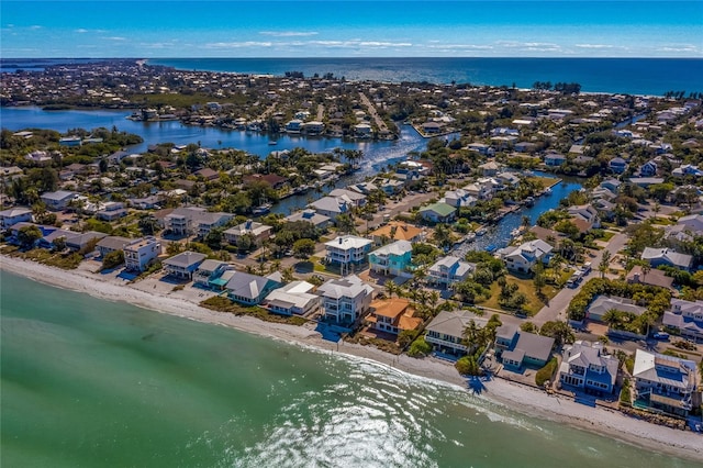 drone / aerial view with a water view and a beach view