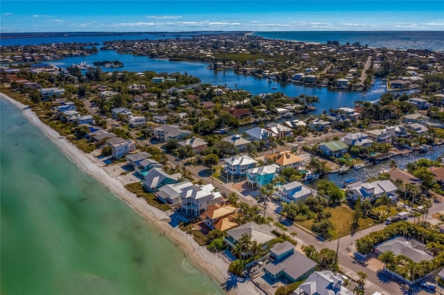 birds eye view of property with a water view and a view of the beach