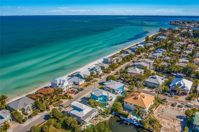 bird's eye view with a water view and a beach view