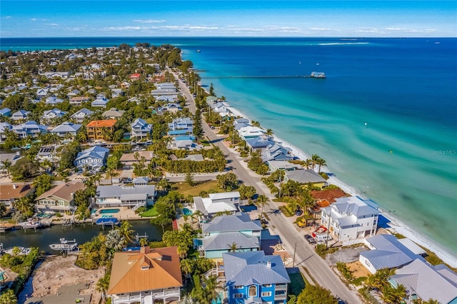 birds eye view of property featuring a beach view and a water view