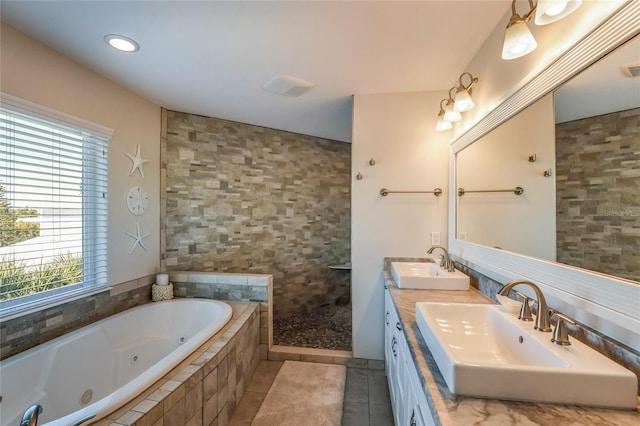 bathroom featuring tile patterned floors, vanity, and shower with separate bathtub