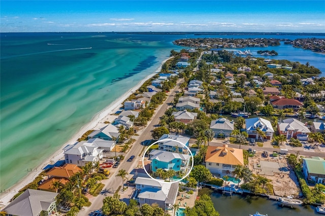 birds eye view of property featuring a view of the beach and a water view