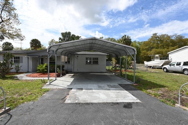 exterior space with a carport and a front lawn