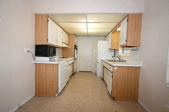 kitchen with white dishwasher, light tile floors, gas cooktop, white cabinets, and sink