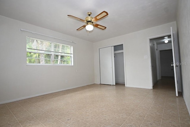 unfurnished bedroom with light tile floors, a closet, and ceiling fan