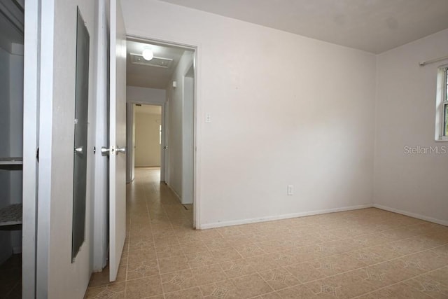 spare room with light tile floors